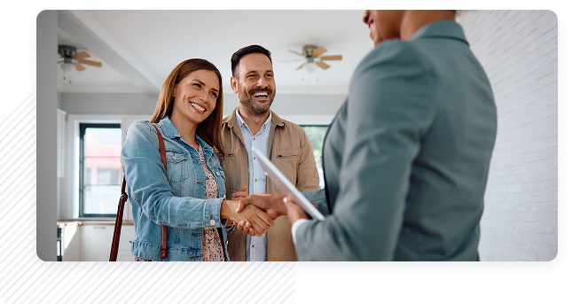 Happy couple shaking hands with agent