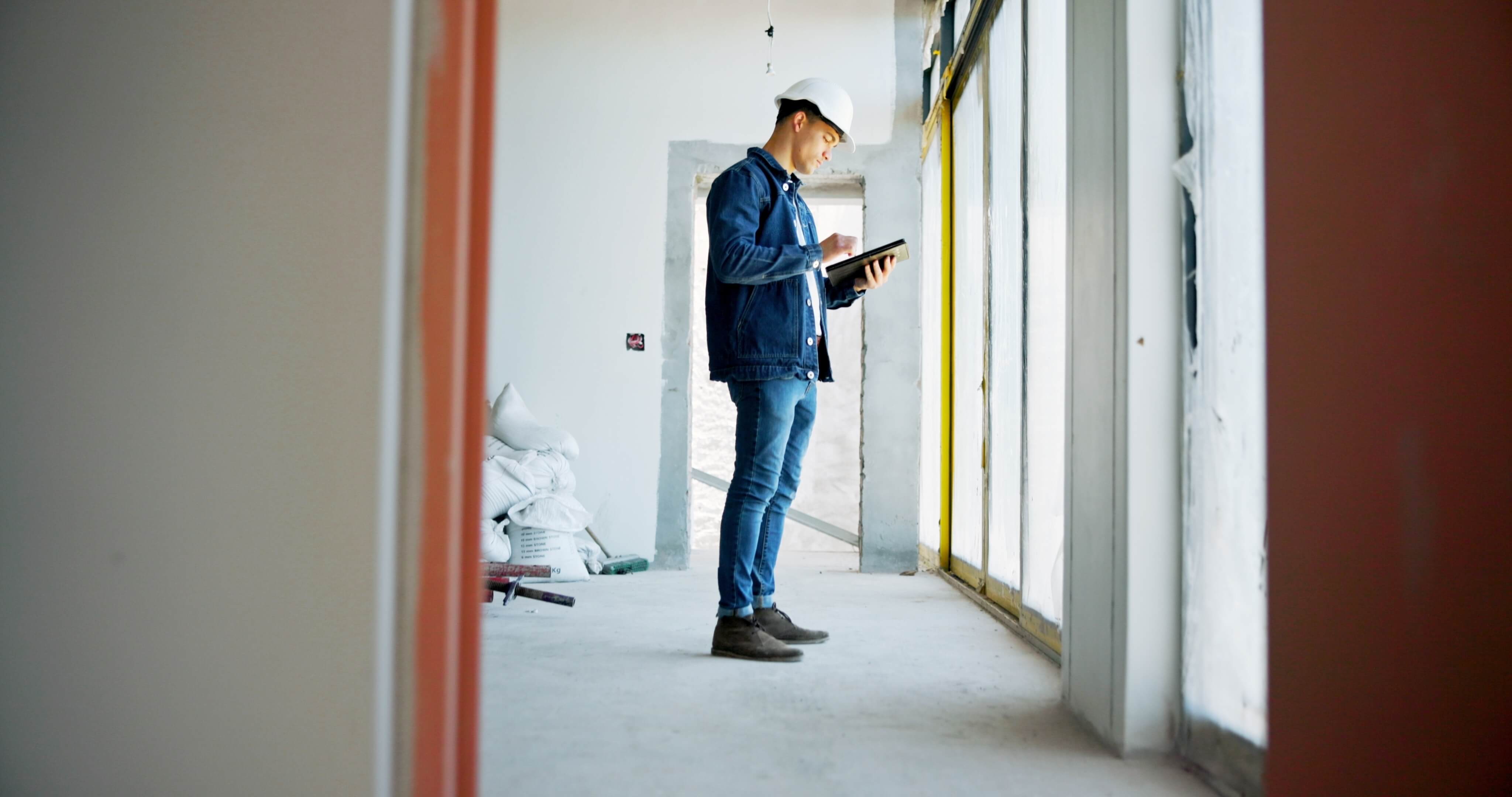 Builder using tablet at construction site