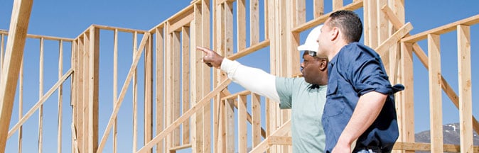 Two construction workers reviewing plans on jobsite
