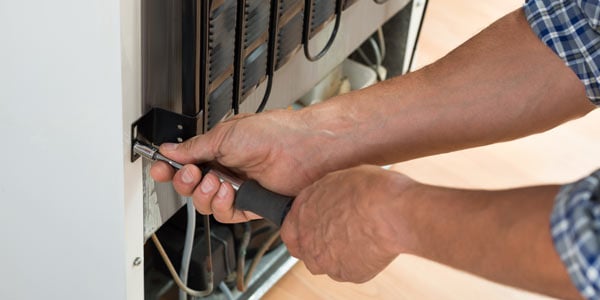 Man repairing fridge